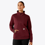 Person wearing a maroon colored sweatshirt that is 1/2 zip and has a large collar.