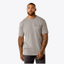 Man wearing a gray t-shirt with a small logo on a white background