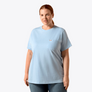 Woman wearing a light blue t-shirt with a small logo on a white background