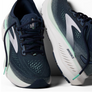 Navy and gray running shoes with white soles on a white background