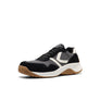 Black, grey and white sneaker with a brown sole