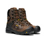Pair of brown work boots with black soles on a white background