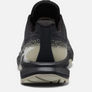 Back view of a black shoe with tan accents against a white background.