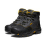 Pair of gray and black safety boots with yellow accents on a white background
