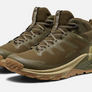 Pair of green shoes with khaki accents and Keen logo on the side, against a white background.