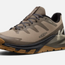 Side view of a light brown shoe with dark brown, black and olive accents with the Keen logo on the side.