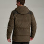Back view of a person wearing a dark brown jacket with black jeans against a medium grey background.