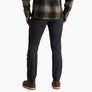 Person wearing dark grey pants with a flannel against a white background.