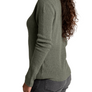 Person wearing a dark green sweater with grey pants against a white background.