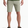 Person wearing pale green shorts with a dark green shirt and brown shoes against a white background.