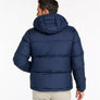 Back view of a person wearing a navy blue jacket with a hood against a white background.
