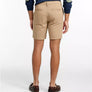 Person wearing beige shorts on a white background