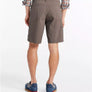 Person wearing brown shorts on a white background
