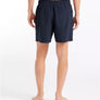 Person wearing black shorts on a white background