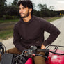 Person wearing a black hoodie on a four wheeler.