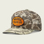 Mesh Camo trucker hat with Marsh Wear Co on the front with a beige background
