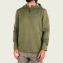 Person wearing a green 1/4 zip hoodie with a brand logo on the upper right side against a blank background