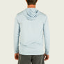 Light blue long sleeve worn by a person on a beige background
