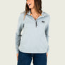 Woman wearing a light blue 1/4 zip pull over sweatshirt with a small logo n the front
