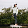 Women standing on a dock with a fishing pole wearing dark grey drawstring pants