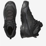 A pair of all black shoes with grey accents against a white background.