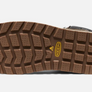 Bottom sole that is light brown and has a yellow keen logo against a white background.