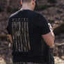 Person wearing a black short sleeve shirt that has an image colored in camo on most of the back of the shirt.