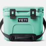 Bright seafoam colored Yeti Hard cool with black accents and a Yeti logo on the from against a white background