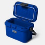 Angled view of a blue yeti hard cooler that is open and has a Yeti logo on the front and inside of the lid against a white background.