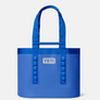 Front view of a Yeti carryall bag that has a yeti patch on the front that is silver and the bag is a royal blue color.