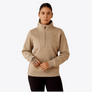 Person wearing a tan 1/2 zip sweatshirt with a large collar against a grey background.