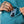 Up close image of a person putting their cell phone into the special pocket inside a the large pocket of a swearshirt.