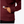 Close up image of a person putting there hand in the pocket of a maroon colored long sleeve shirt.
