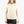 Person wearing a cream colored long sleeve with black shorts against a white background.