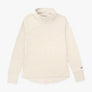 Cream colored long sleeve shirt with mock turtle neck against a white background.