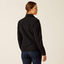 Back view of a person wearing a black jacket against a beige background.