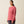 Person wearing a long sleeve pink shirt that says Ariat down the side of the arm and has a chest pocket.
