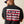 Man wearing a black t-shirt with 'Ariat Work' design on the back against a beige background