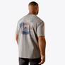 Man wearing a grey shirt with a dog and American flag with a white background