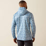 Man wearing a blue camo hoodie with a beige background