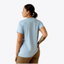 Person wearing a light blue t-shirt and beige pants on a white background