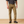 Man wearing khaki pants and a dark grey shirt with black boots.