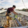 Man working on a construction site wearing khaki pants. 