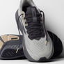 Gray and black running shoe with 'Brooks' branding on a white background