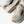 White and gray running shoes with brown soles on a white background