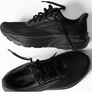 Black running shoes against a white background