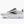 White, black and rose gold running shoes against a white background