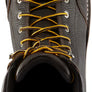 Brown work boot with yellow laces against a white background