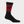 Tall black sock with red accents and a moose on the leg portion of the sock against a white background.