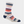 A striped sock that is purple, white, pink, grey, brown and navy blue with navy blue toe and heel area against a white background.